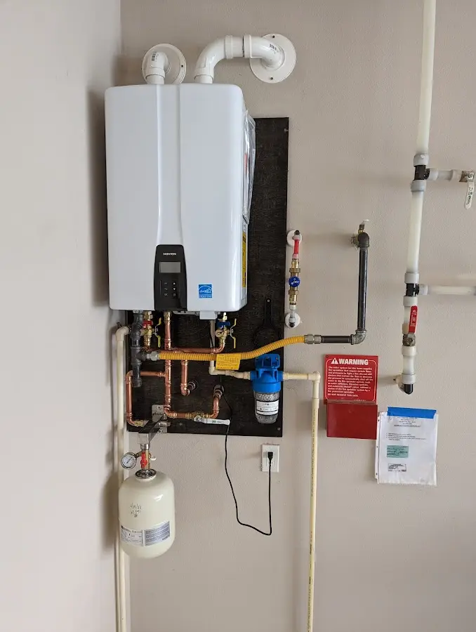 Professional plumber installing copper piping in a Fort Thomas home